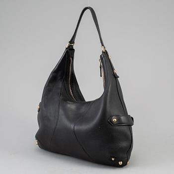 GUCCI, a leather horse-bit bag.