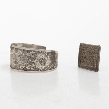 Two silver buttons, a belt buckle, an armring and a box, Persia, first part of the 1900s.