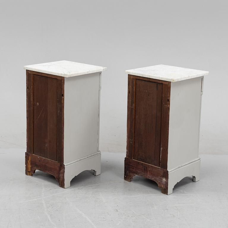 A pair of marble top bedside tables, first half of the 20th Century.