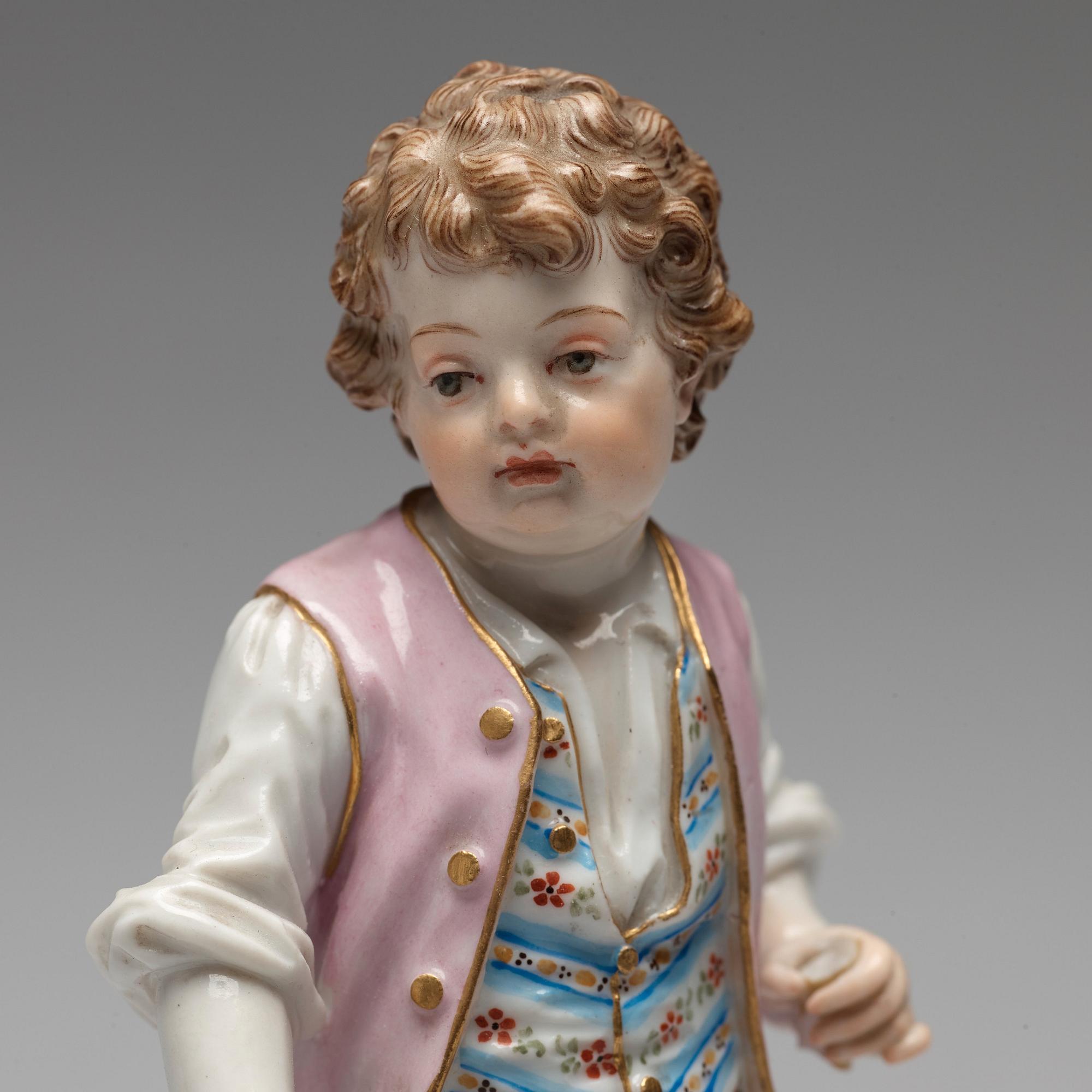 A Meissen figure of a young boy with grapes, 1890's.