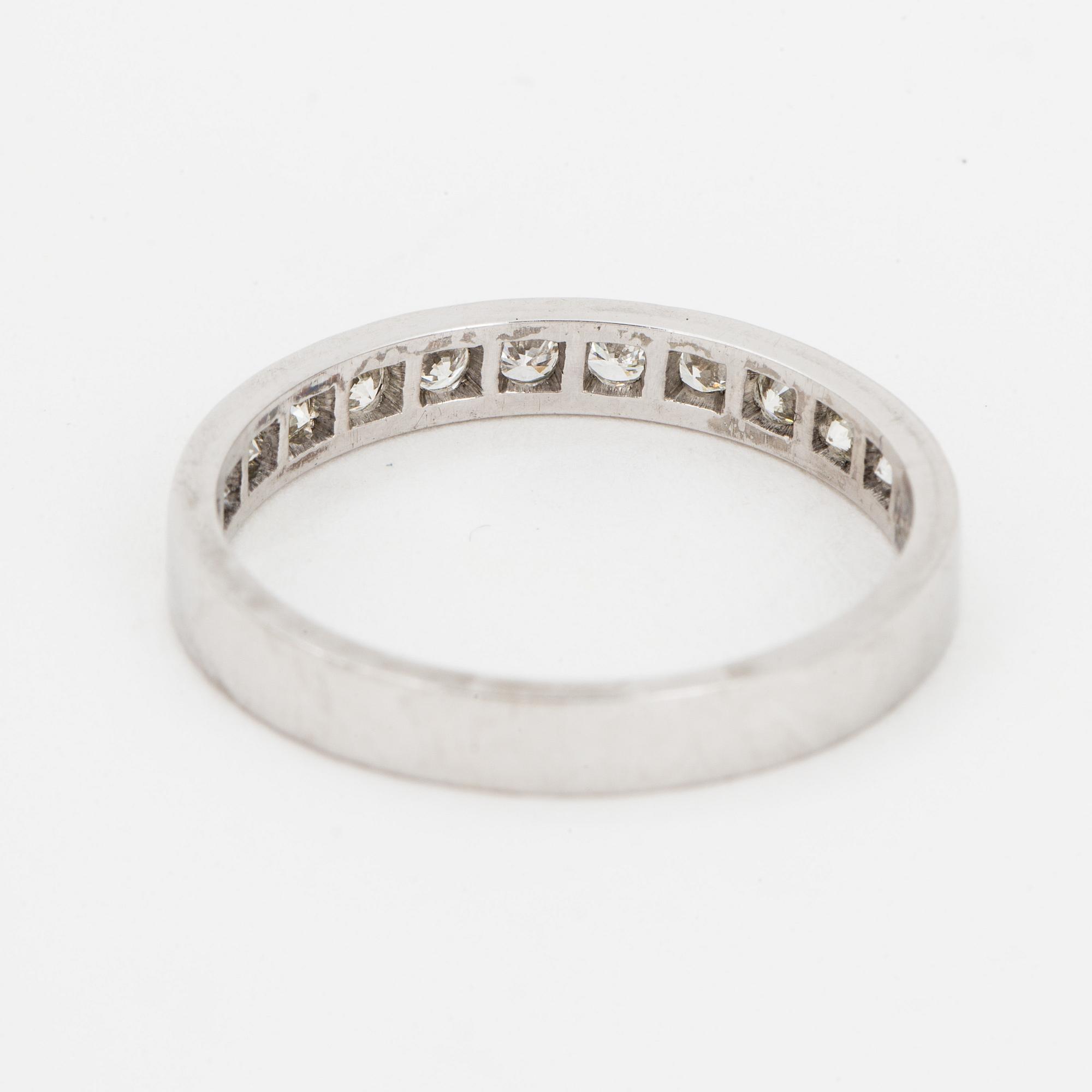 Brilliant-cut diamond half-eternity ring.
