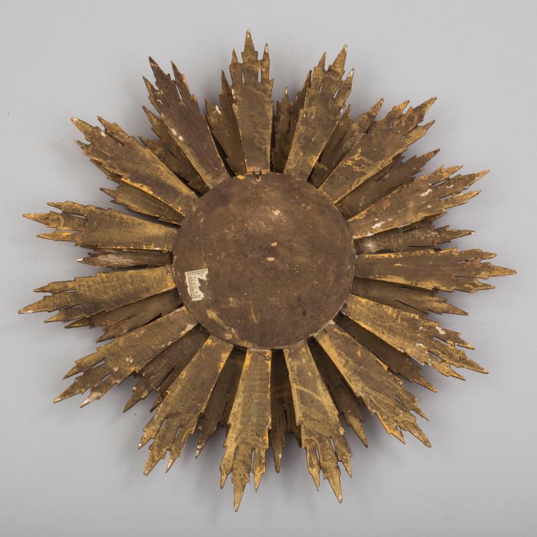 A first half of the 20th century sun mirror.