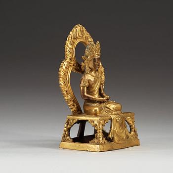 A gilt bronze figure of Bodhisattva, Qing dynasty, 18th Century. With inscription to base.