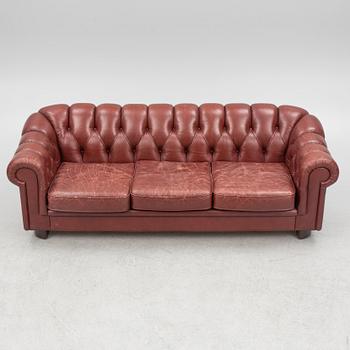 A sofa and a pair of armchairs, 'Chesterfield model', late 20th Century.