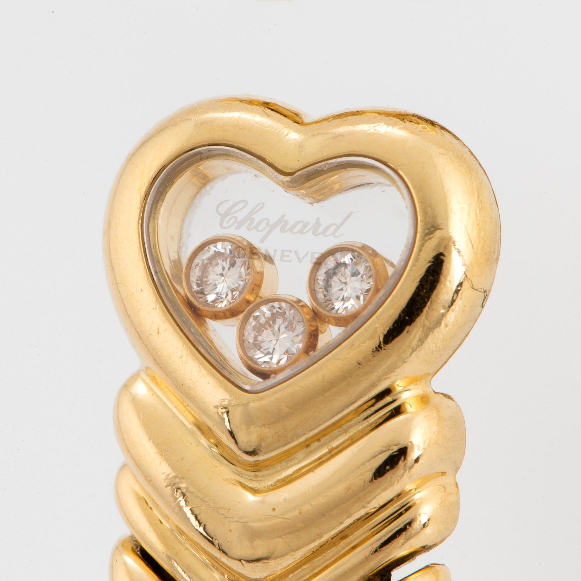 A Chopard "Happy Diamond" bangle in 18K gold.