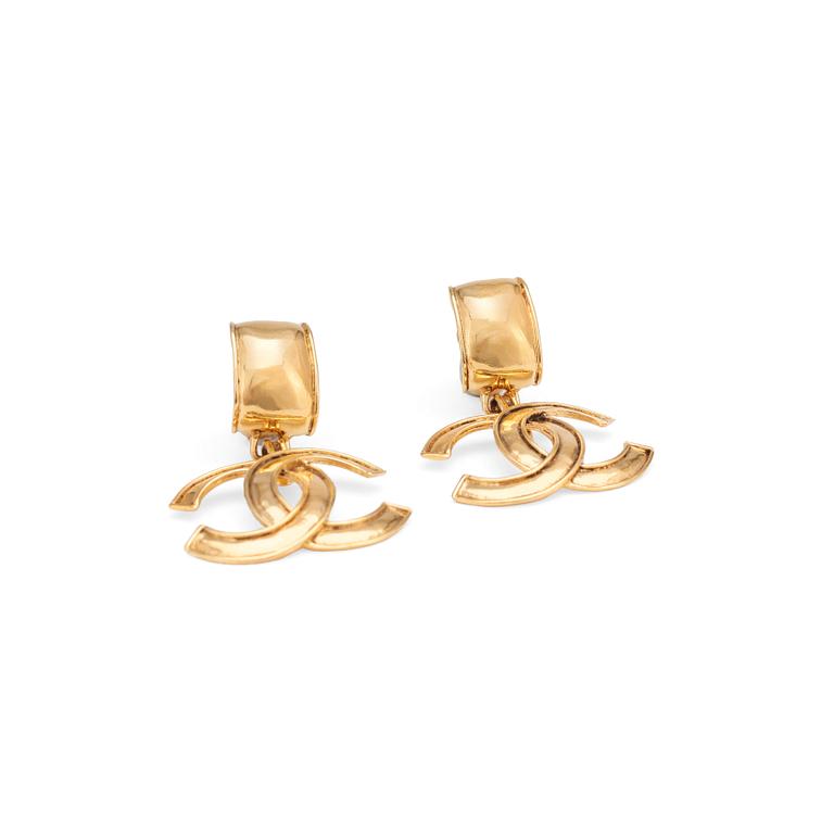 CHANEL, a pair of gold colored logo earclips.