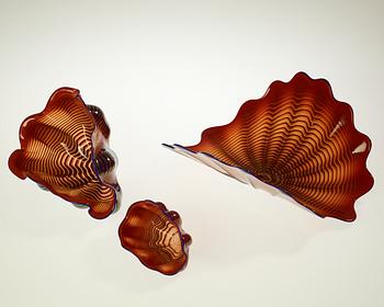 A Dale Chihuly three piece seaform set of red and blue glass, Seattle, USA.