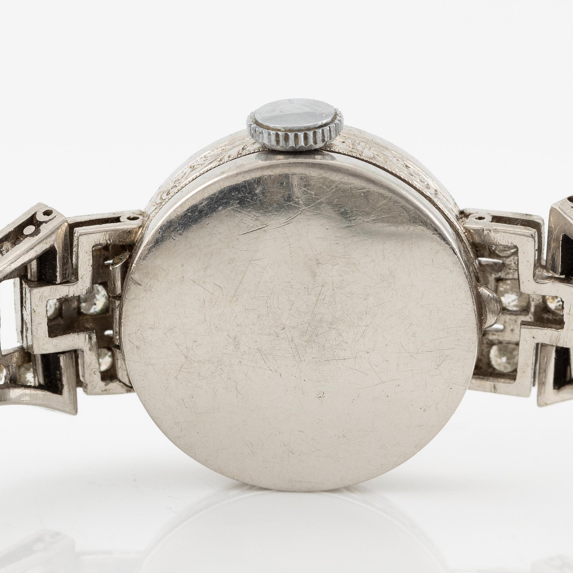 Damarmbandsur, platina med åttkantslipade diamanter, med textilrem.