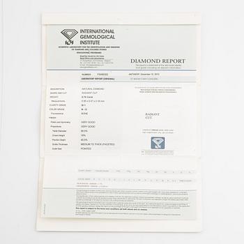 An 18K gold ring set with a radiant-cut diamond.