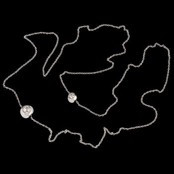 An 18K white gold 'Cave' necklace set with two round, brilliant-cut diamonds by Jacqueline Rabun for Georg Jensen.