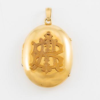 Medallion with monogram 18K gold.