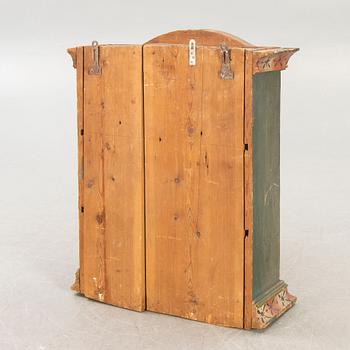 A painted Swedish wall cabinet dated 1808.