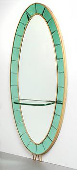 Italian designer, a wall mirror, 1950-60's. Emerald green tinted glass and brass frame.