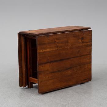 A stained pine gate-leg table, 19th Century.