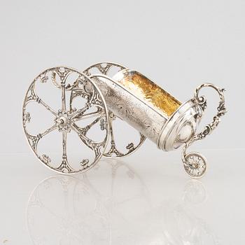 A silver bottle holder with wheels, 20th Century.