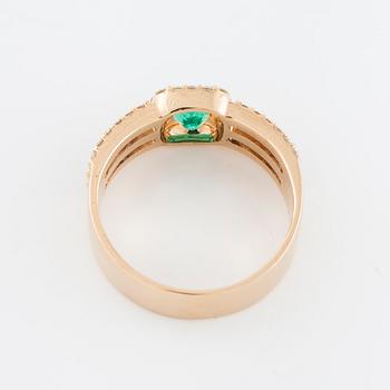 A faceted emerald and brilliant cut diamond ring.