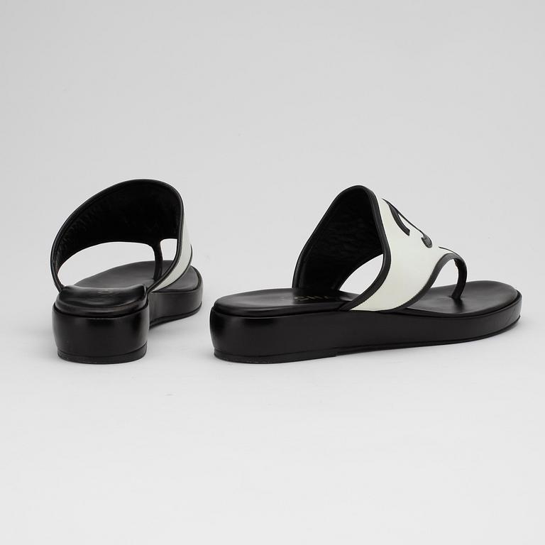 CHANEL, a pair of black and white sandalettes.