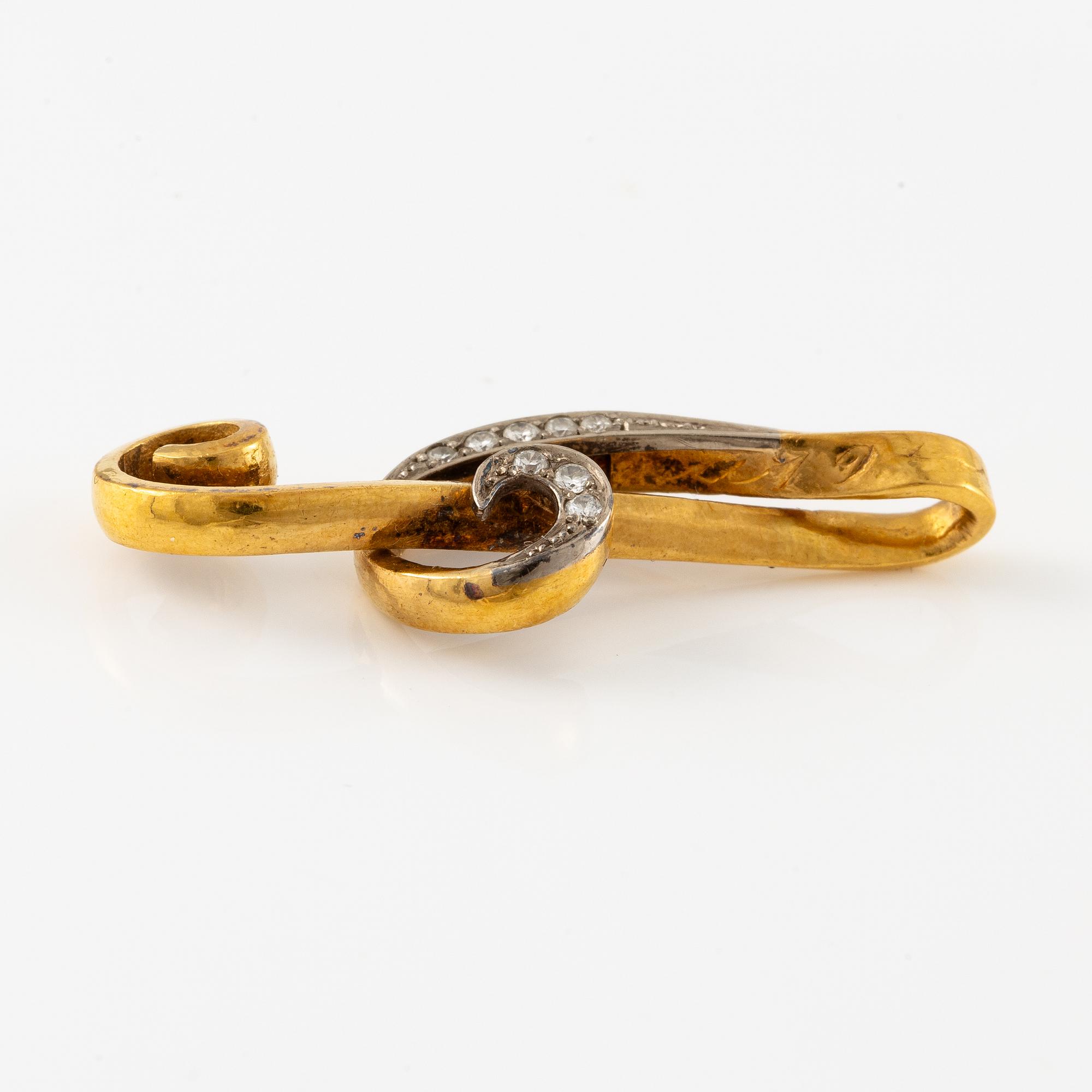 Hänge, i form av G-klav, 23K guld med briljantslipade diamanter.