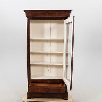 A walnut display cabinet around 1900.