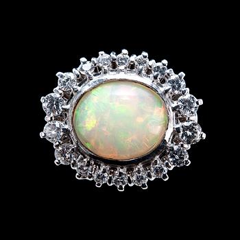 36. A RING, Opal c. 3.42 ct, 18 brilliants c. 1.00 ct.