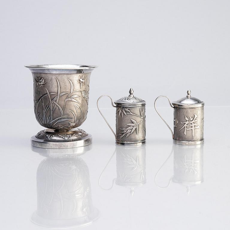 A Chinese Export silver beaker and two silver mustard pots, early 20th century.