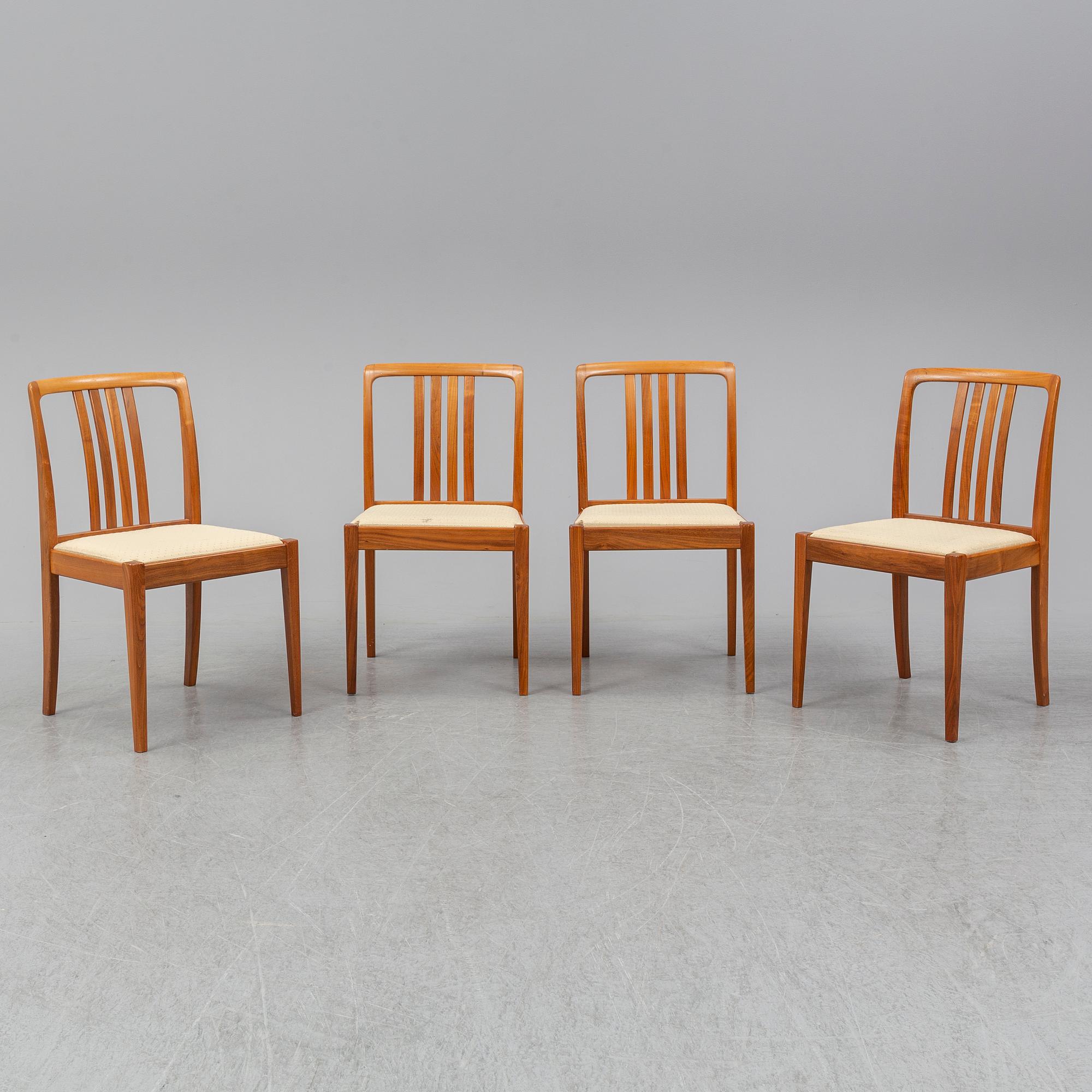 A 1950/60s teak and valnut table and four chairs.