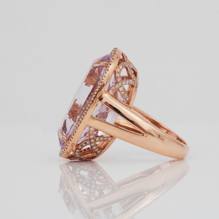 A kunzite, circa 30.00 ct, and diamond, circa 1.10 ct, ring.