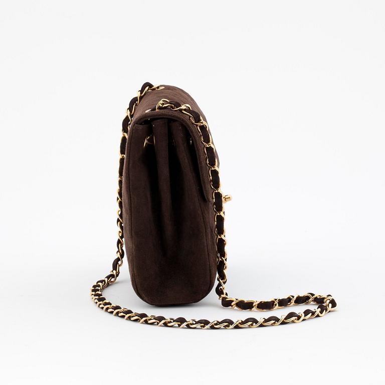 CHANEL, a brown suede shoulderpurse.