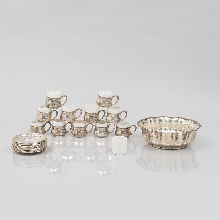 A set of eleven silver cups with saucers and a bowl, Germany, 20th Century.