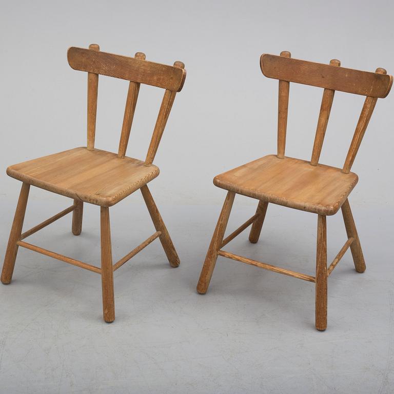 a paor of 1940's pine wood chairs.