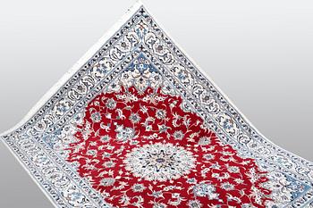 A carpet, Nain, part silk, ca 238 x 170 cm.