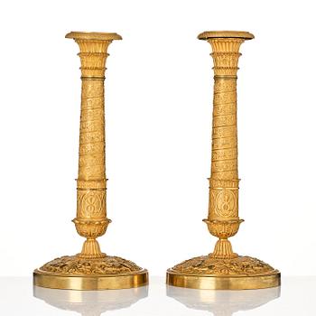 A pair of French Empire ormolu candlesticks, Paris, early 19th century.