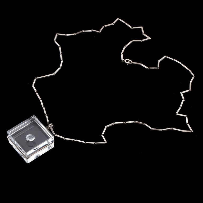 A glass pendant designed by Gunnar Cyrén and a silver necklace.