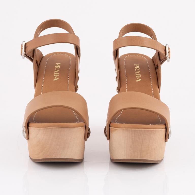 Prada, a pair of wood and leather sandals, size 37.