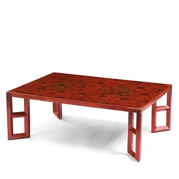 1007. A red lacquered table, China, 20th century.