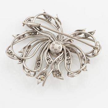 A brooch in palladium set with a half pearl and eight-cut diamonds, W.A. Bolin.