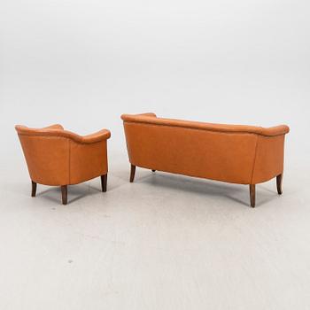 A leather sofa and armchair 1940s.