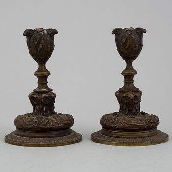 A PAIR OF BRONZE CANDLESTICKS, mid 19th century.