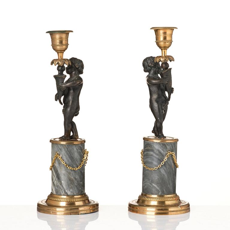 A pair of French Louis XVI ormolu and marble candlesticks, late 18th century.