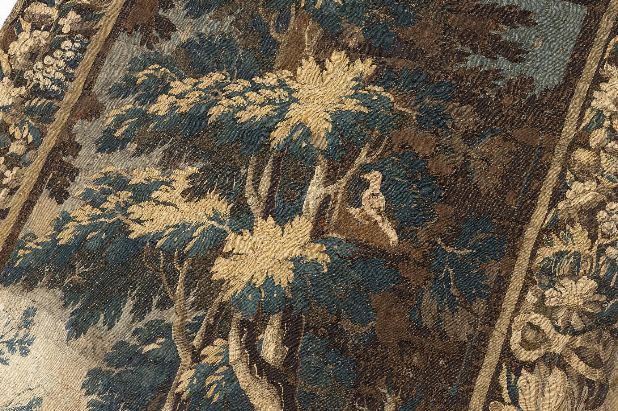 A 17th century Flemish 'verdur' entre-fenêtre tapestry, c. 268 x 130 cm.