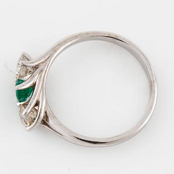A emerald and brilliant cut diamond ring.