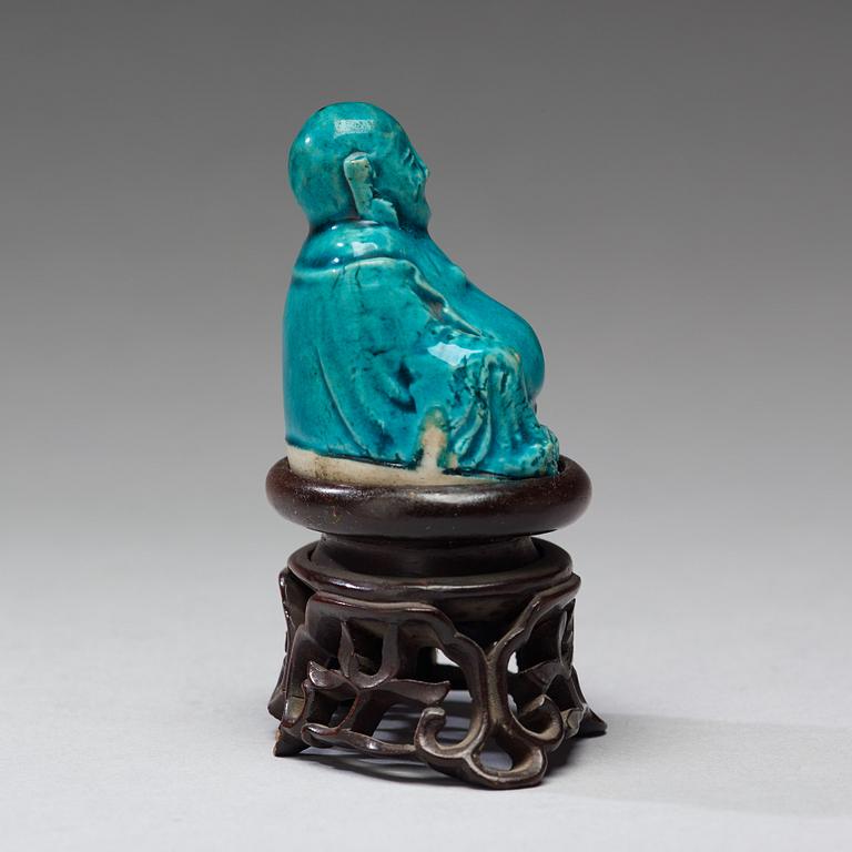 A turquoise glazed figure of Buddai, Qing dynasty, early 18th Century.