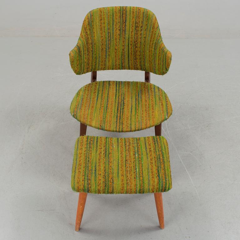 An IKEA armchair with a stool.