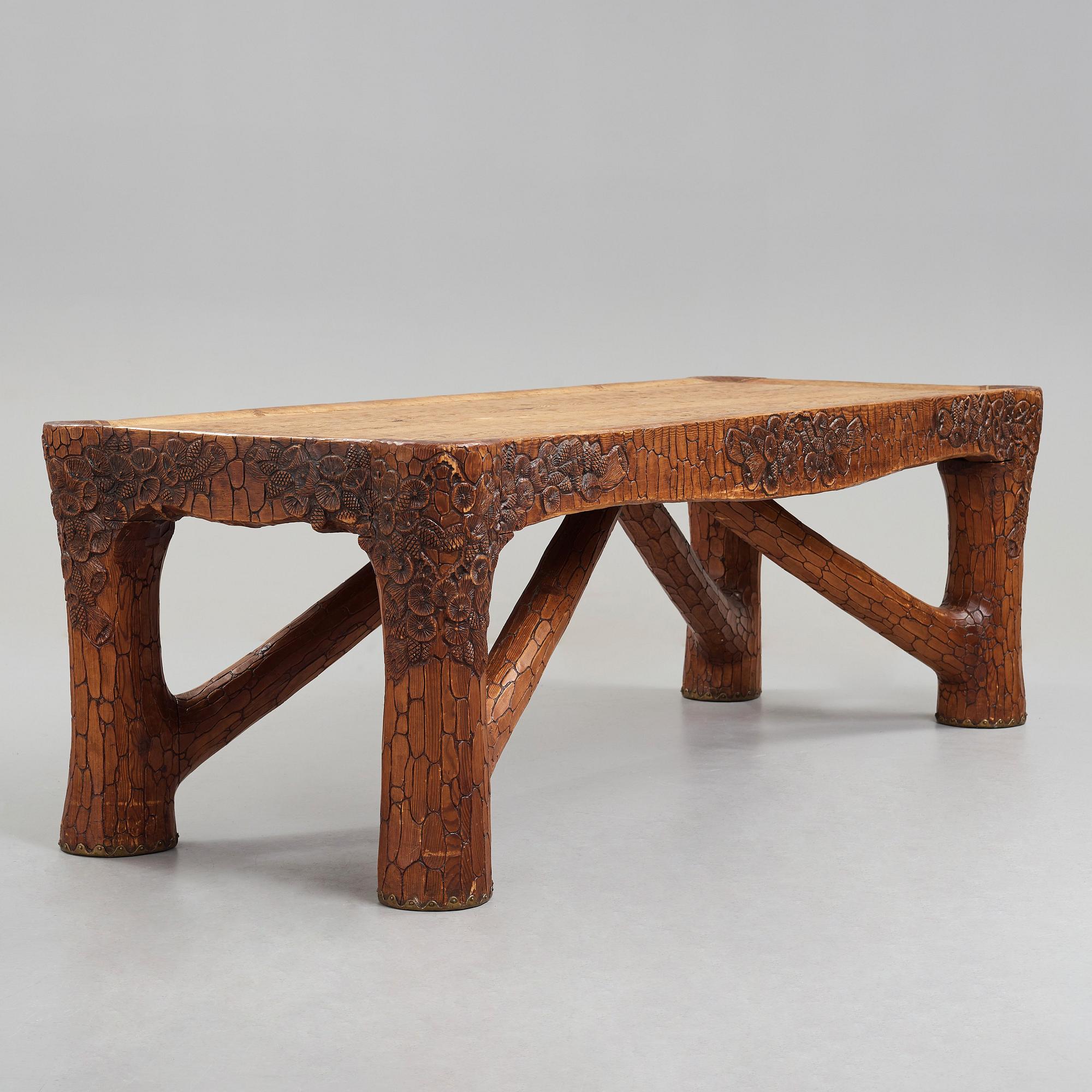 Gustaf Fjaestad, an Art Nouveau carved pine table, Arvika Sweden 1914, a double to the table in the Thiel Collection,