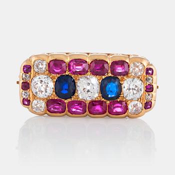 A brooch set with old-cut diamonds and faceted sapphires and rubies.