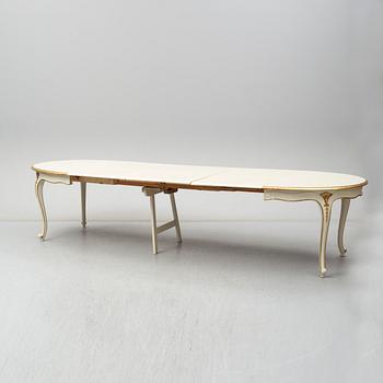 A dining table width twelve chairs, first half of the 20th century.