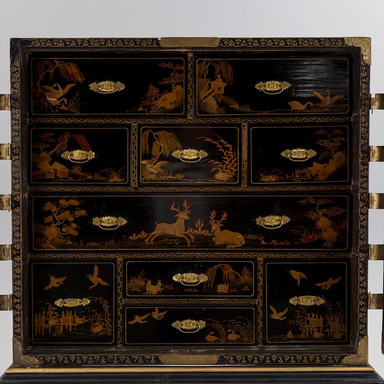 AN early 18TH CENTURY PROBABLY ENGLISH Japanned laquer cabinet on stand.