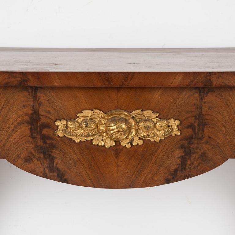 En Empire mirror with console table, first half of the 19th century.