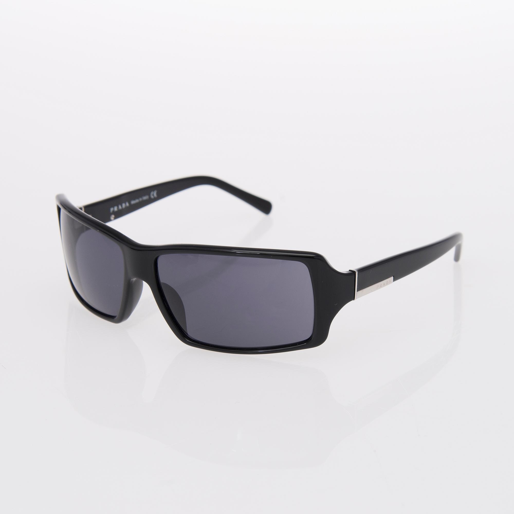Two Pairs of Sunglasses, Prada and Chanel.