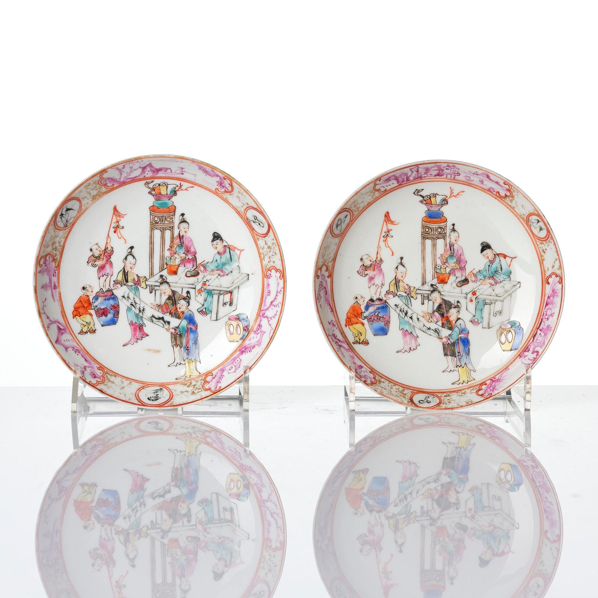 A pair of famille rose 'figural' tea cups with saucers, Qing dynasty, Qianlong (1736-95).